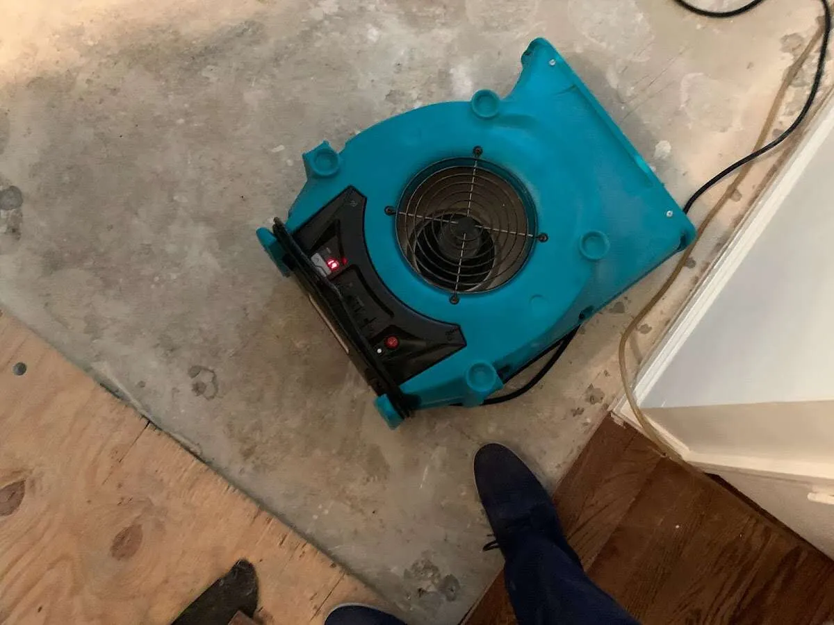 Air mover drying subfloor during Commercial Water Damage Restoration in Royal Palm Beach